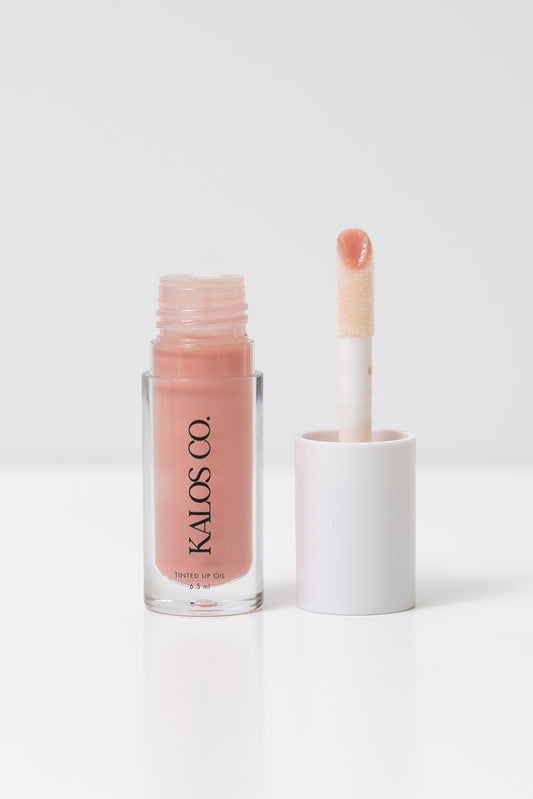 Lip gloss with applicator and 'Kalos Co.' branding on a white background